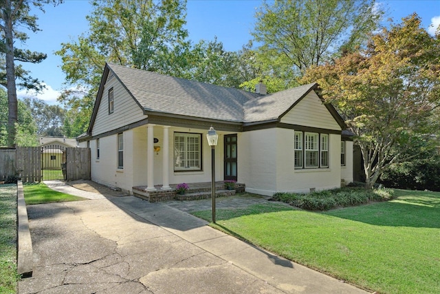 view of front facade with a front yard and a porch