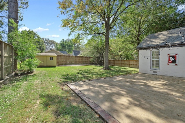 view of yard with a shed and a patio