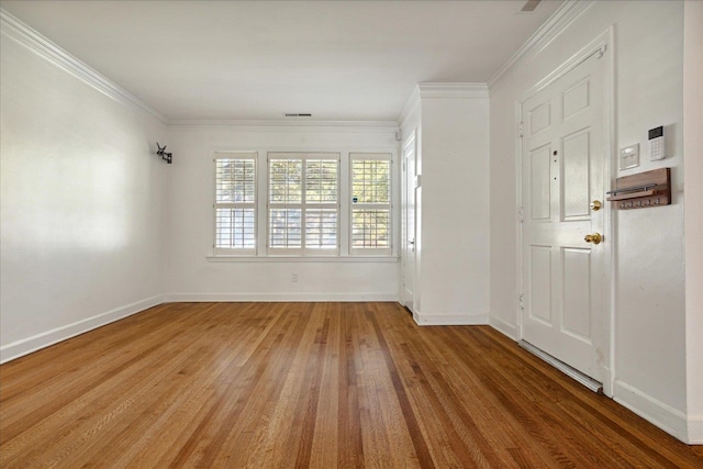 unfurnished room with ornamental molding and hardwood / wood-style floors