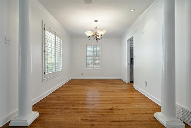 unfurnished dining area with ornamental molding, a chandelier, and light wood-type flooring