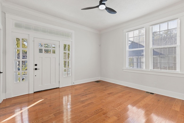 foyer featuring ornamental molding, a textured ceiling, hardwood / wood-style flooring, and ceiling fan