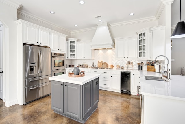 kitchen featuring appliances with stainless steel finishes, custom exhaust hood, white cabinets, and sink