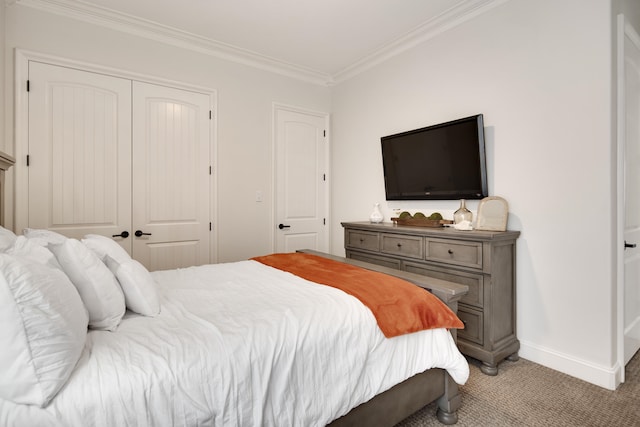 carpeted bedroom with ornamental molding and a closet