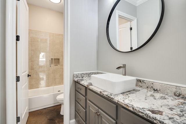 full bathroom with ornamental molding, toilet, vanity, tiled shower / bath combo, and tile patterned flooring