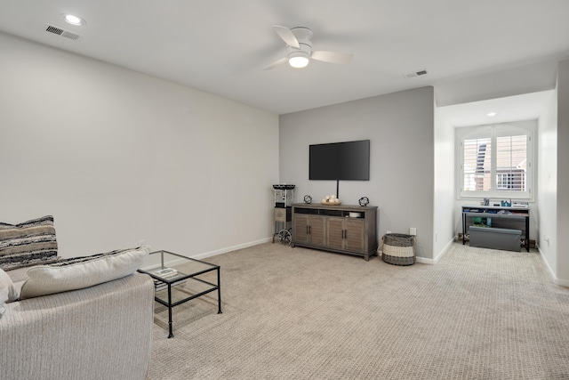 living room with light colored carpet and ceiling fan