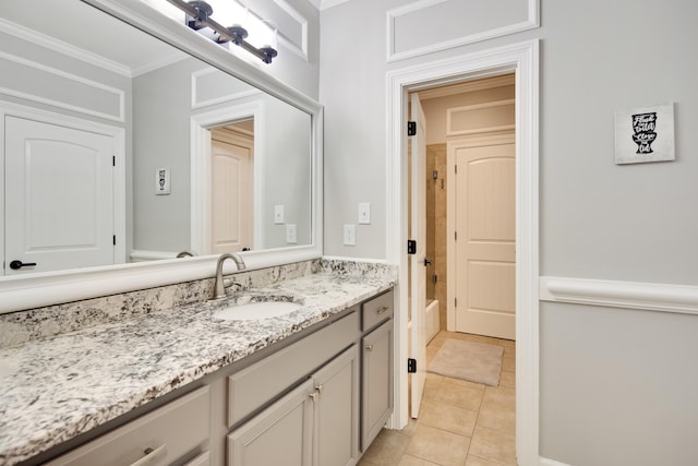 bathroom featuring vanity, ornamental molding, and tile patterned flooring