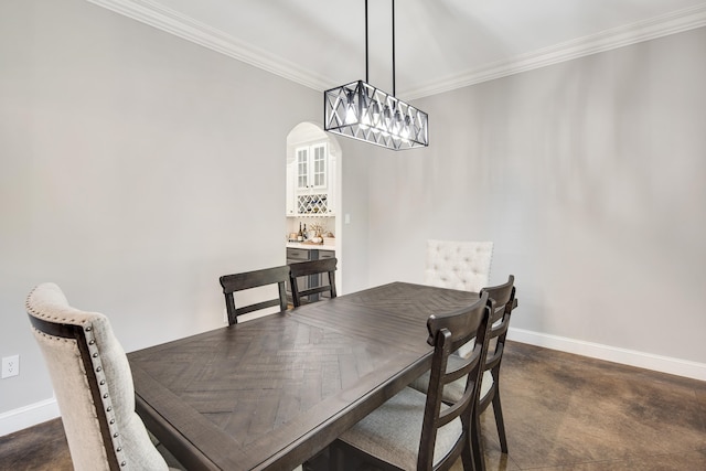 dining space featuring crown molding