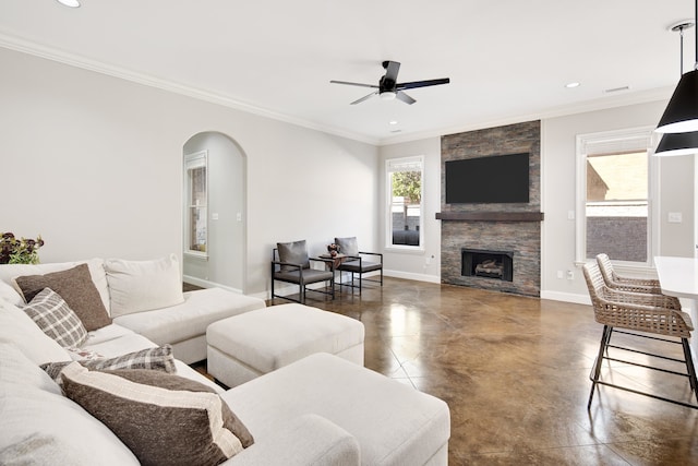 living room with ornamental molding, a fireplace, and ceiling fan