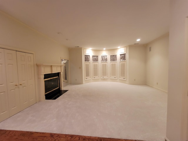 unfurnished living room featuring light colored carpet