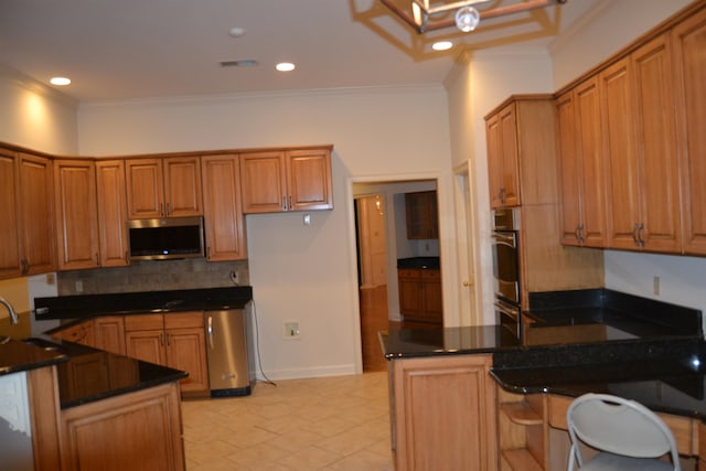 kitchen with crown molding, kitchen peninsula, backsplash, and dark stone countertops