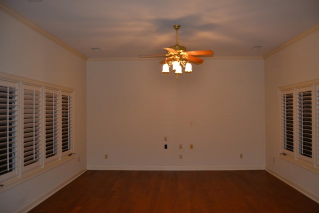 spare room with dark wood-type flooring, ceiling fan, and ornamental molding