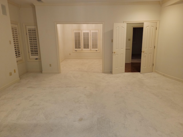 unfurnished bedroom featuring light carpet and ornamental molding