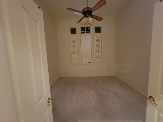 unfurnished room with ceiling fan and light carpet