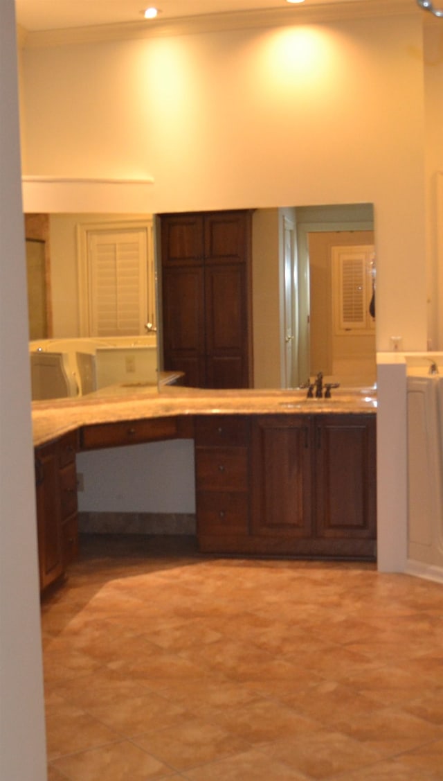 bathroom featuring ornamental molding and sink