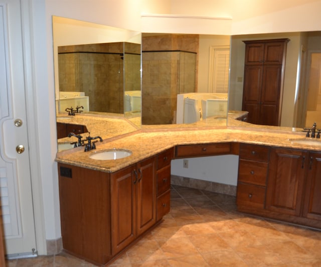 bathroom with a shower with door and vanity