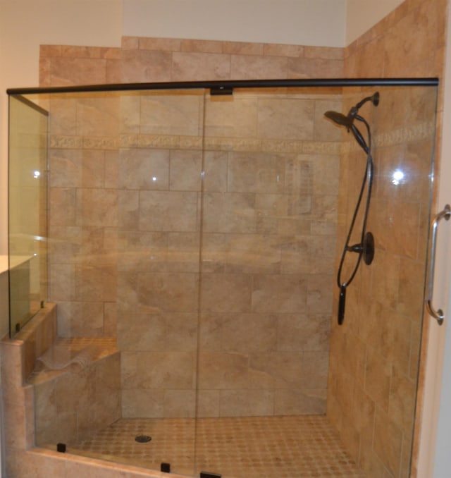 bathroom featuring a shower with door