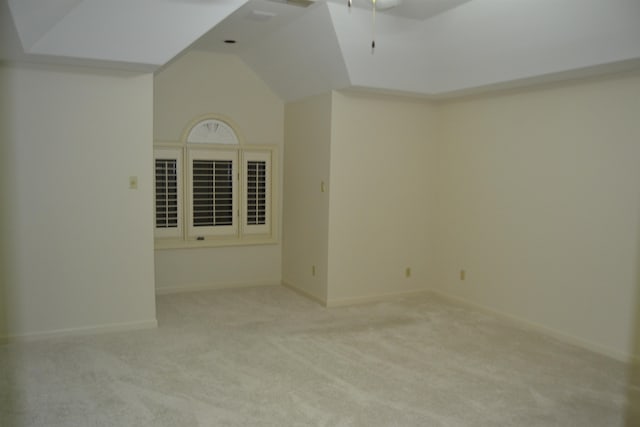 spare room featuring light colored carpet and high vaulted ceiling