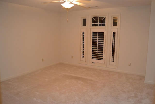 empty room featuring light colored carpet and ceiling fan