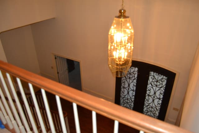 staircase featuring a chandelier