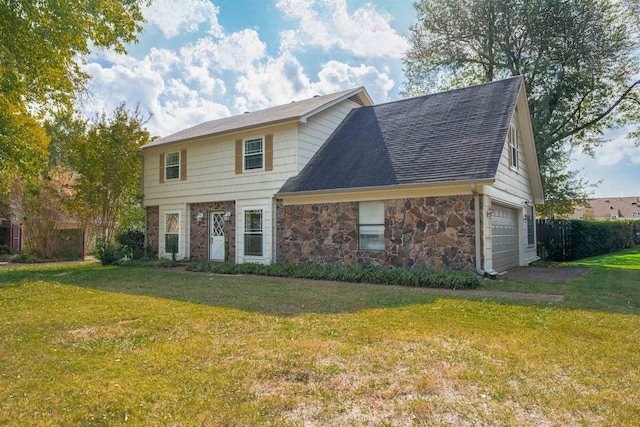 view of front of property with a front yard and a garage