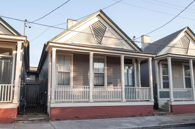 376 Mulberry St, Memphis, TN 38103 - shotgun-style home with covered porch and a chimney