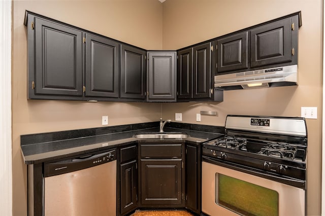 376 Mulberry St, Memphis, TN 38103 - kitchen with appliances with stainless steel finishes, a sink, dark stone countertops, dark cabinetry, and under cabinet range hood
