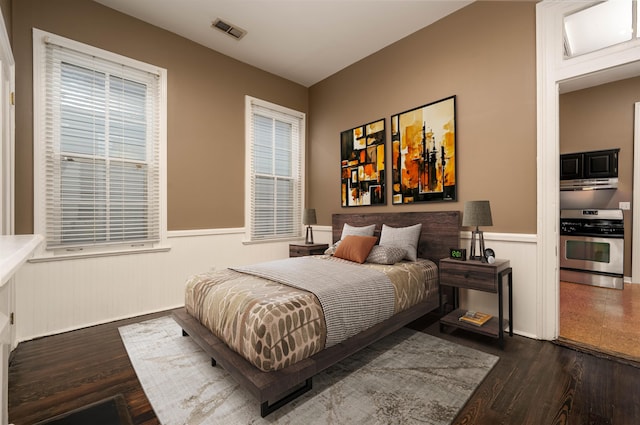 376 Mulberry St, Memphis, TN 38103 - bedroom with visible vents, a wainscoted wall, multiple windows, and wood finished floors