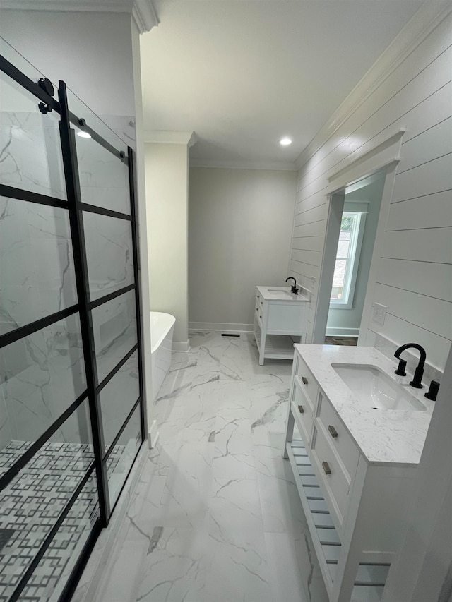 full bathroom featuring a soaking tub, two vanities, marble finish floor, crown molding, and a sink