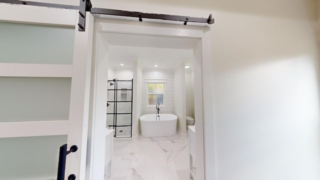 bathroom with recessed lighting, marble finish floor, and a freestanding bath