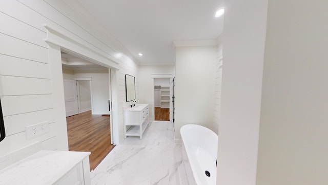 bathroom with a freestanding tub, recessed lighting, vanity, marble finish floor, and crown molding