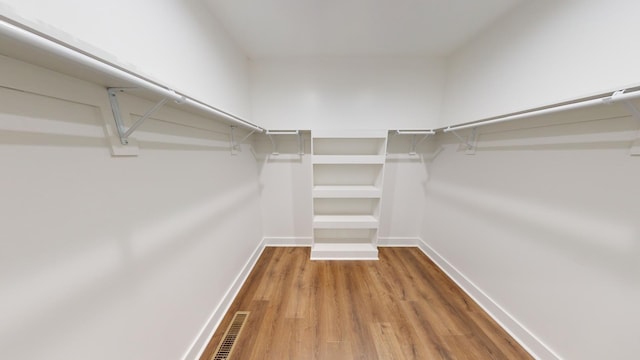 spacious closet featuring visible vents and wood finished floors