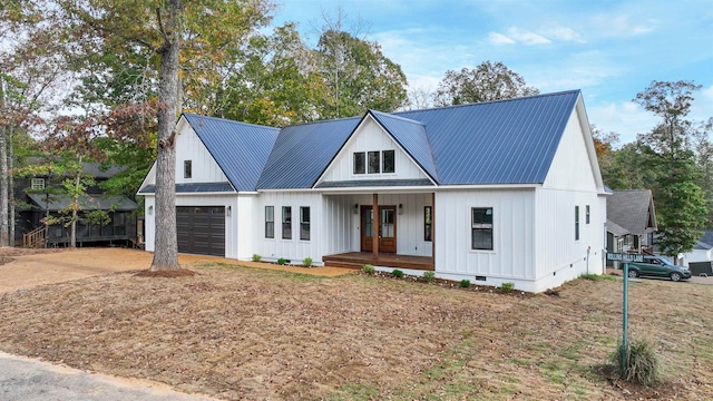 modern inspired farmhouse featuring metal roof, a porch, an attached garage, concrete driveway, and crawl space