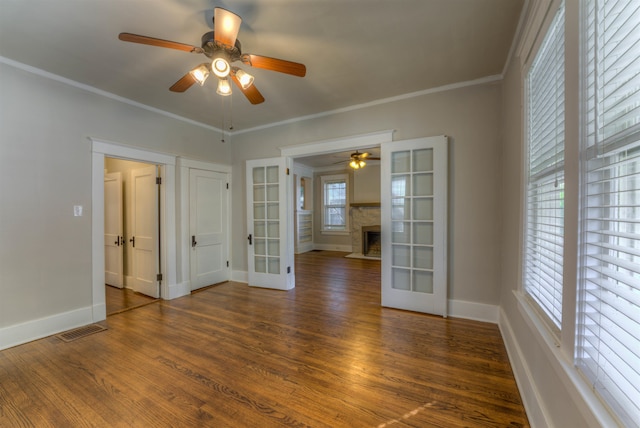 unfurnished room with french doors, a wealth of natural light, and dark hardwood / wood-style flooring