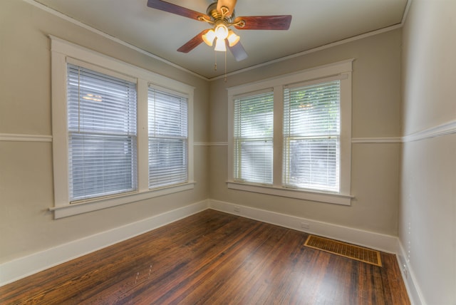 spare room with ornamental molding, dark wood-type flooring, and ceiling fan