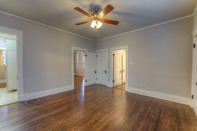 unfurnished bedroom with connected bathroom, ornamental molding, dark hardwood / wood-style floors, and ceiling fan