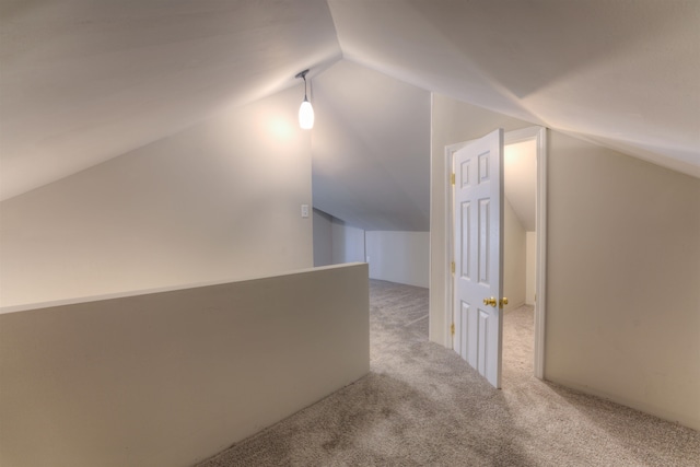 bonus room featuring light carpet and lofted ceiling