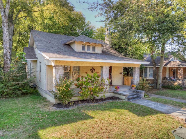 bungalow-style house with a front lawn and covered porch