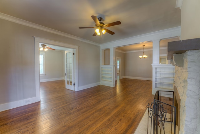 unfurnished living room featuring ornamental molding, decorative columns, wood-type flooring, and ceiling fan with notable chandelier