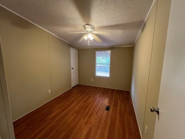 unfurnished room with a textured ceiling, crown molding, hardwood / wood-style flooring, and ceiling fan