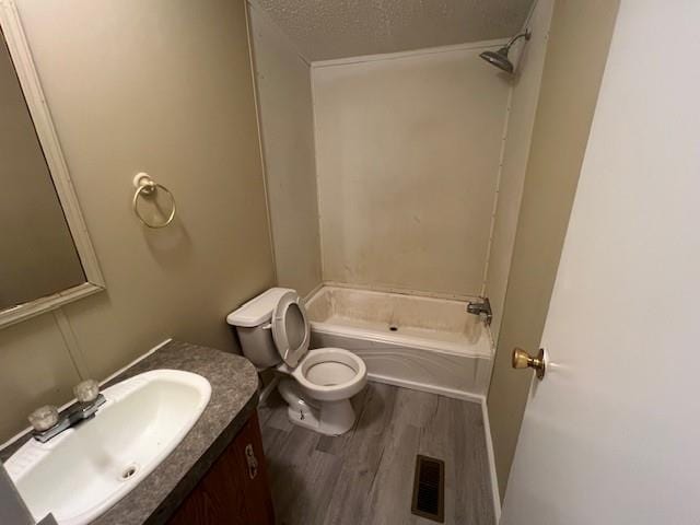 full bathroom with vanity, toilet, shower / tub combination, and hardwood / wood-style floors