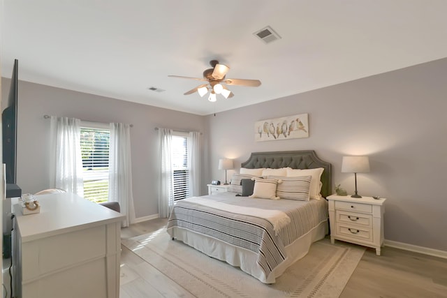 bedroom with light wood-type flooring and ceiling fan