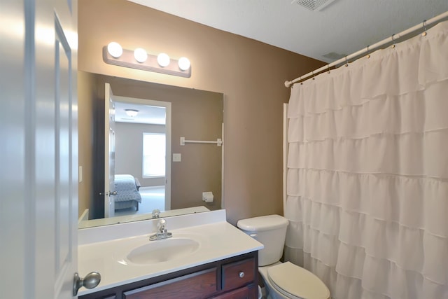 bathroom featuring vanity, a shower with shower curtain, a textured ceiling, and toilet