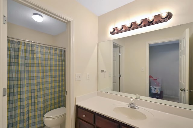 bathroom with vanity, toilet, and a shower with curtain