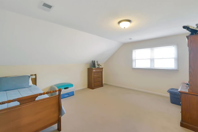 bedroom featuring light carpet and vaulted ceiling