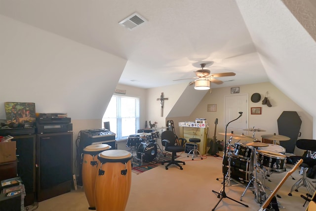 carpeted office with lofted ceiling and ceiling fan