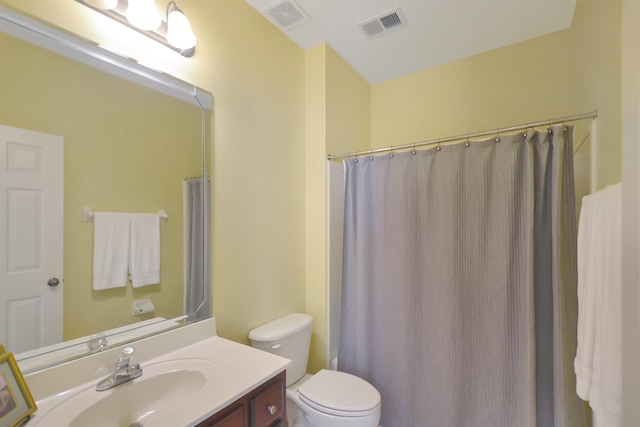 bathroom with vanity, toilet, and walk in shower