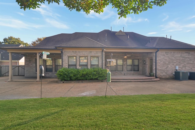 rear view of house with a yard, a patio, and cooling unit