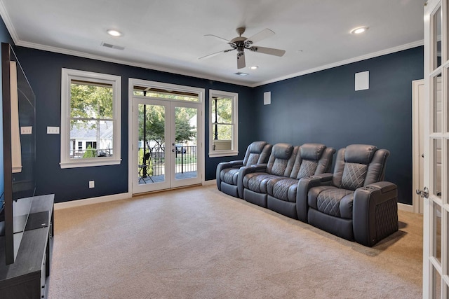 carpeted home theater room featuring french doors, ornamental molding, and ceiling fan