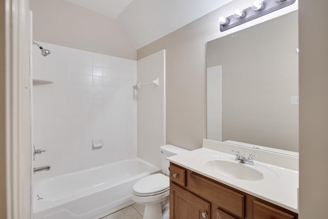 full bathroom with tiled shower / bath, vaulted ceiling, toilet, vanity, and tile patterned floors