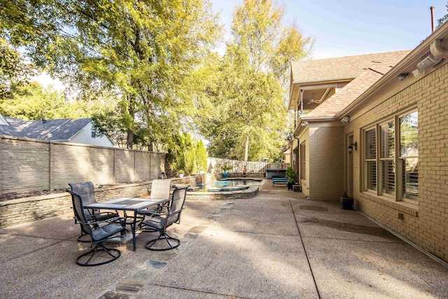 view of patio featuring an in ground hot tub